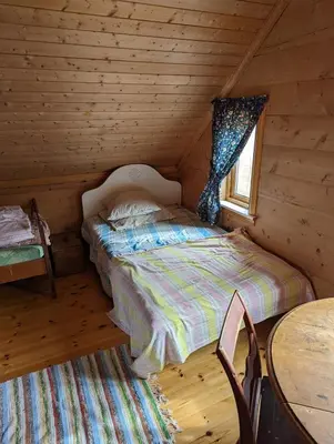 a bedroom with a bed in a log cabin at The queen path right from the house in Tveit