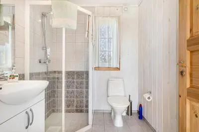 a bathroom with a shower and a toilet and a sink at The queen path right from the house in Tveit