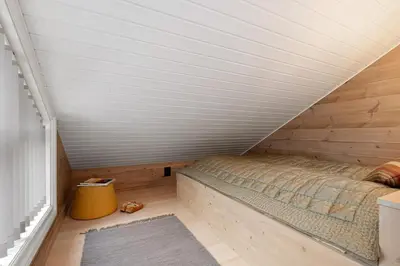 a small bedroom with a bed in a attic at Idyllic Apartment at Strandafjellet in Stranda