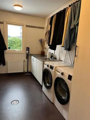a laundry room with a washing machine and a sink at Bergen - Home, Close to Airport and the city in Bergen