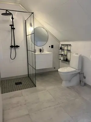 a bathroom with a toilet and a shower and a mirror at Bergen - Home, Close to Airport and the city in Bergen