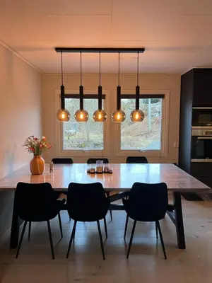 a dining room with a large wooden table and chairs at Bergen - Home, Close to Airport and the city in Bergen