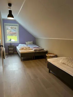 a bedroom with two beds and a window at Bergen - Home, Close to Airport and the city in Bergen
