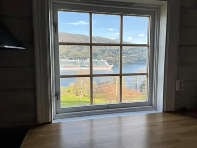 an open window with a view of a body of water at Stryn - Faleide - Cabin Fjord view in Stryn