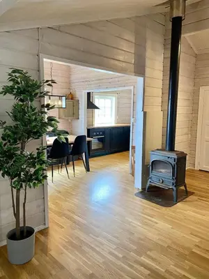 a living room with a stove and a dining room at Stryn - Faleide - Cabin Fjord view in Stryn