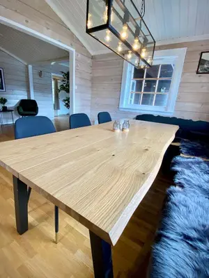 a large wooden table in a room with a rug at Stryn - Faleide - Cabin Fjord view in Stryn
