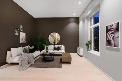 a living room with a white couch and a mirror at City Centrum Villa Apartments w parking in Bergen