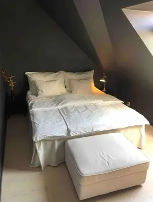 a bed with white sheets and pillows in a room at City Centrum Villa Apartments w parking in Bergen