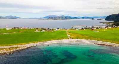 an aerial view of a golf course and the ocean at Nesheim in Alnes