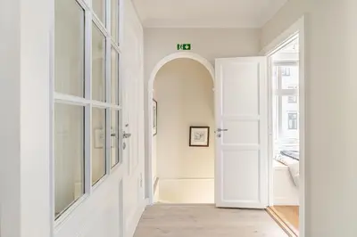 a hallway with an archway and a white door at Skuteviken House in Bergen