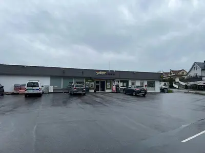 a car dealership with cars parked in a parking lot at #Beautiful outdoor area and cozy small cottage# in Fotlandsvåg
