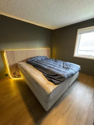 a bedroom with a bed in a room with a window at 2 Bedroom Apartment with free parking lot in Bergen