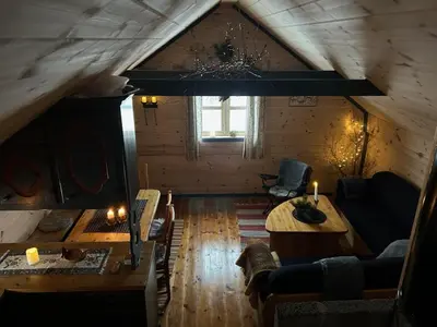 a living room with a table in a cabin at Støl ved Sognefjorden in Berge