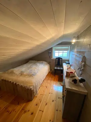 a bedroom with a bed and a desk in a room at Perla i Nordfjord in Emhjella