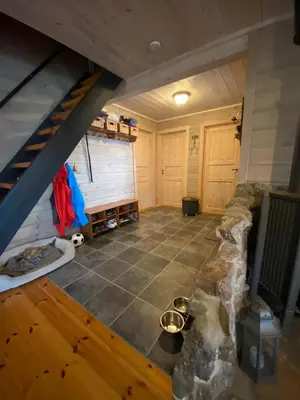 an attic room with a staircase and a stone floor at Perla i Nordfjord in Emhjella