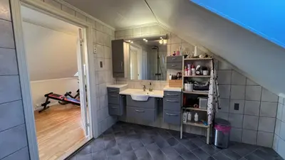 a bathroom with a sink and a mirror at Villa with heated pool and magnificent view in Bergen