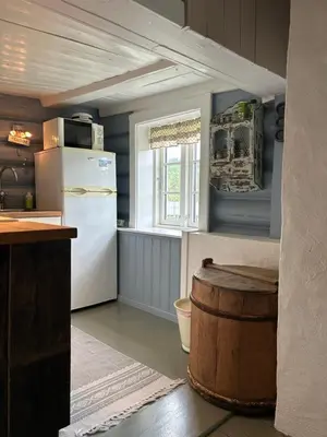 a kitchen with a white refrigerator and a barrel at Tuddal Hyttegrend, GAMLESTUGU, Telemark in Tuddal