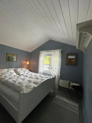 a bedroom with a white bed and a window at Tuddal Hyttegrend, GAMLESTUGU, Telemark in Tuddal