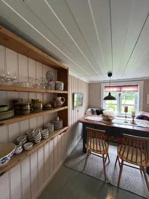 a kitchen with a table and chairs in a room at Tuddal Hyttegrend, GAMLESTUGU, Telemark in Tuddal