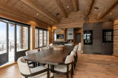 a dining room with a large wooden table and chairs at Nordic Gateway Logde in Hafjell