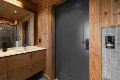 a bathroom with a gray door and a sink at Nordic Gateway Logde in Hafjell