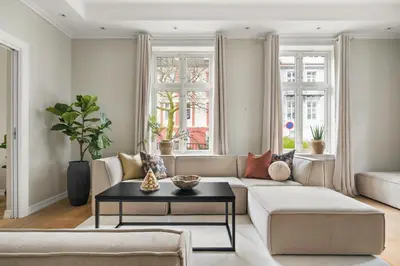 a living room with a couch and a table at Scandinavian Luxury in Bergen's Finest Street in Bergen