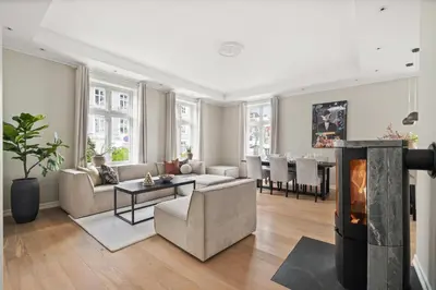 a living room with a couch and a table at Scandinavian Luxury in Bergen's Finest Street in Bergen