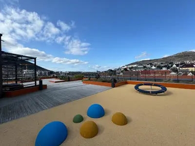 a playground with blue and yellow balls on the ground at Modern, brand-new apartment in the heart of Bergen in Bergen