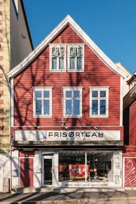 a red building with a store in front of it at Design Apartment by Bryggen - View & Location in Bergen