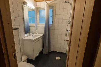 a bathroom with a sink and a toilet and a window at Lemonsjø Fjellstue og Hyttegrend in Randsverk