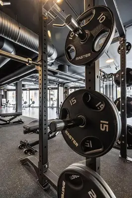 a gym with a bunch of weights on a rack at Modern and practical ski in & out apartment in Kyrkjebøen