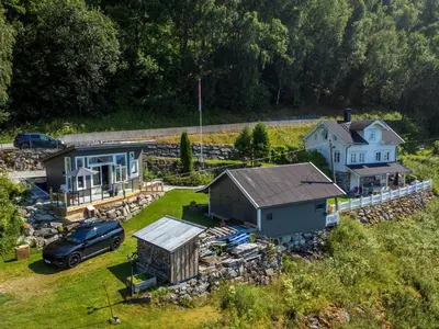 an aerial view of a house and a car at Fjord Cabin with Panoramic View & Private Balcony in Luster