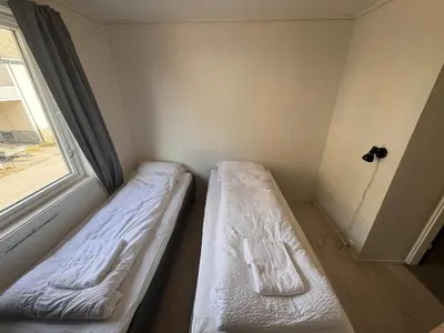 a small room with two beds and a window at Trolltunga Apt for up to 5 people with balcony in Tysso