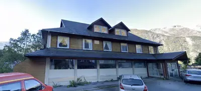 a house with cars parked in a parking lot at Trolltunga Apt for up to 5 people with balcony in Tysso