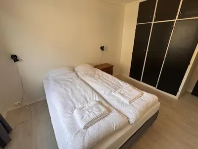 a white bed with towels on it in a room at Trolltunga Apt for up to 5 people with balcony in Tysso