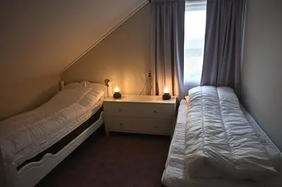 a bedroom with two beds and a window at 4 bedroom house in beautiful Oldedalen in Stryn