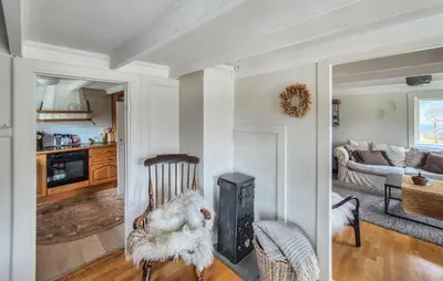 a living room with a wood stove in it at Pet Friendly Home In Nedre Vats in Åmsosen