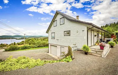 a white house with a porch and a driveway at Nice Home In Lundegrend With Wifi in Grimsland