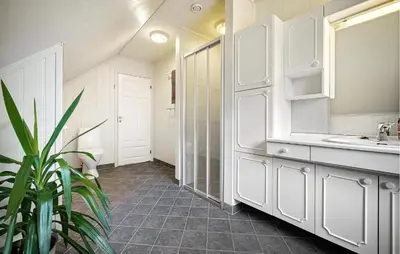 a white bathroom with a sink and a mirror at Nice Home In Lundegrend With Wifi in Grimsland