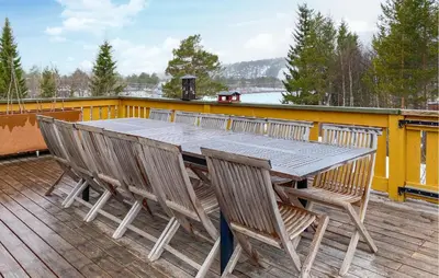 a wooden table and chairs on a deck at Beautiful Home In Bjorli With Wifi in Bjorli