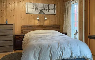 a bedroom with a bed and a dresser and a window at Beautiful Home In Bjorli With Wifi in Bjorli