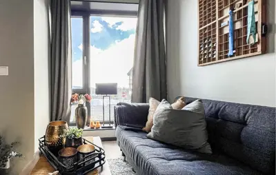 a living room with a blue couch and a window at 2 Bedroom Awesome Apartment In Sjusjøen in Sjusjøen