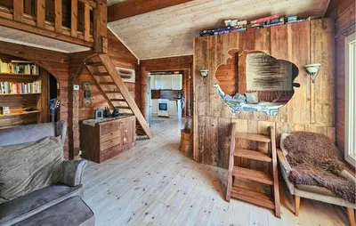 a living room with wooden walls and a staircase in a cabin at Stunning Home In Flesberg With Sauna in Flesberg