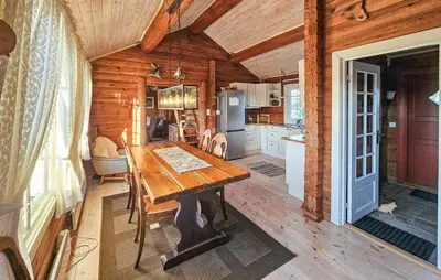 a kitchen with a wooden table in a cabin at Stunning Home In Flesberg With Sauna in Flesberg