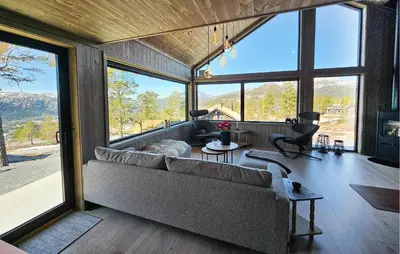 a living room with a couch and large windows at Beautiful Home In Tuddal With Wifi in Tuddal