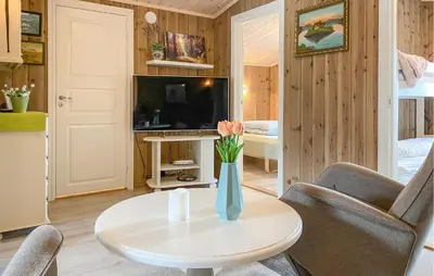 a living room with a vase of flowers on a table at Gorgeous Home In Oppdal With Wifi in Oppdal