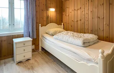 a bedroom with a white bed with a night stand and a window at Gorgeous Home In Oppdal With Wifi in Oppdal