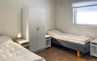 a bedroom with two beds and a cabinet and a window at 5 Bedroom Beautiful Home In Kverva in Kverva
