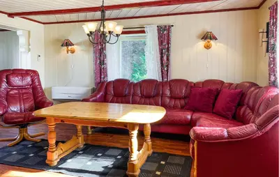 a living room with a red couch and a table at Gorgeous Home In Kverva With Wifi in Kverva