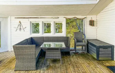 a screened in porch with a table and chairs at Gorgeous Home In Kverva With Wifi in Kverva